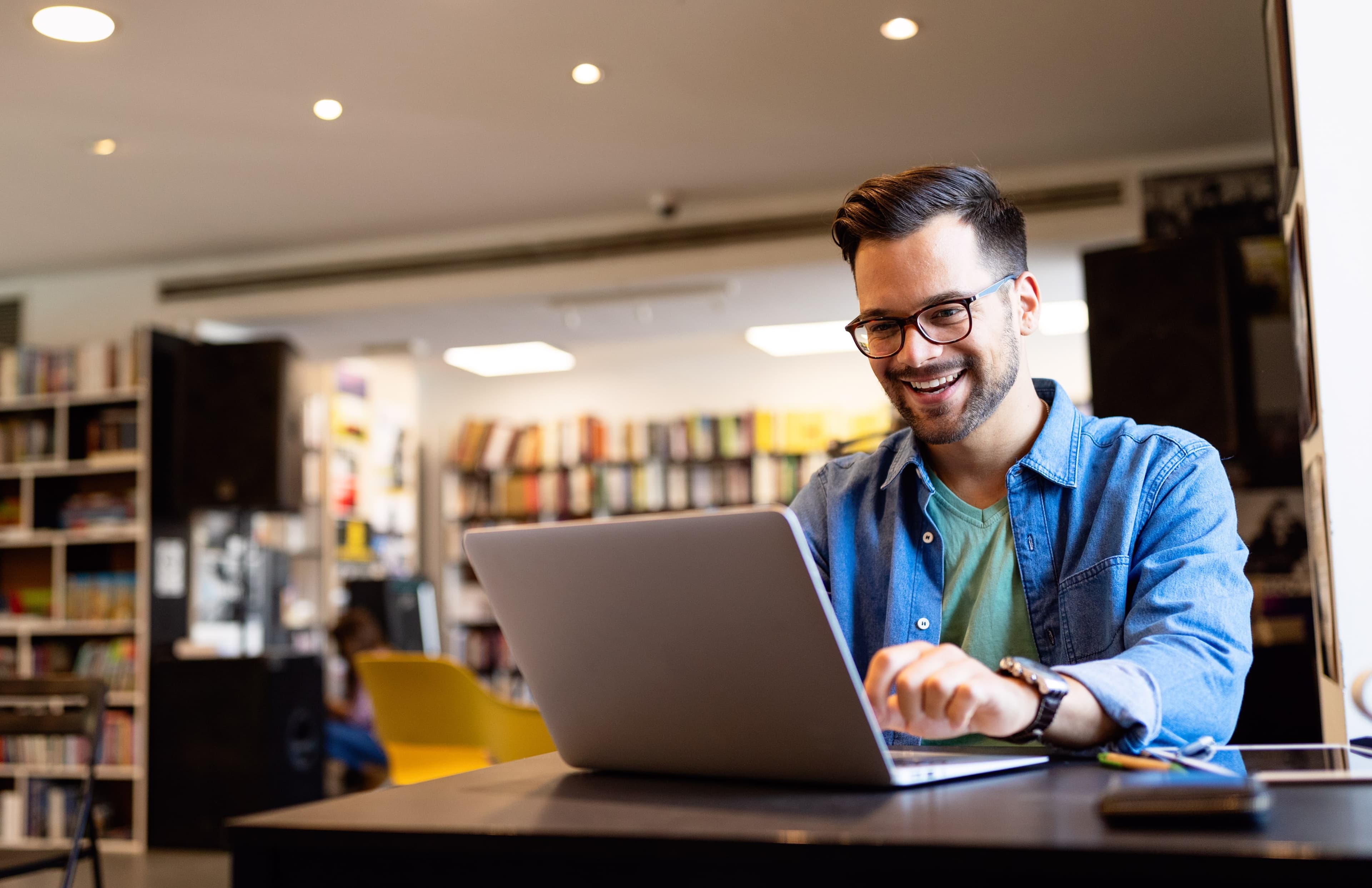 Image of a man typing on a laptop